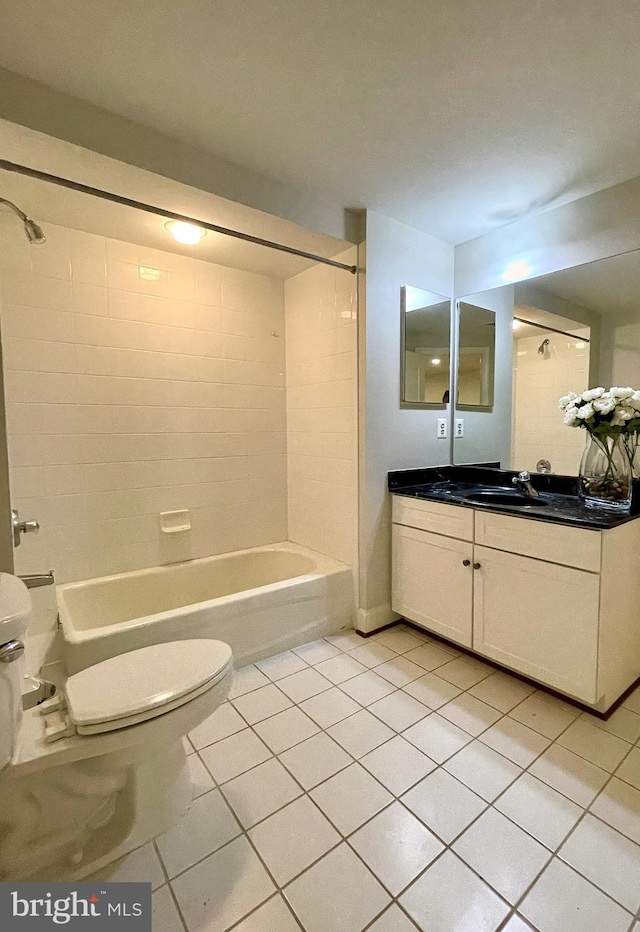 bathroom with toilet, tile patterned flooring, vanity, and shower / washtub combination