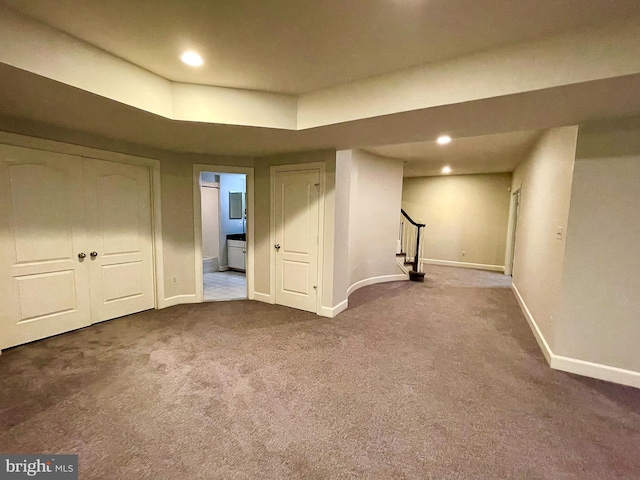 finished basement featuring baseboards, stairs, carpet flooring, and recessed lighting