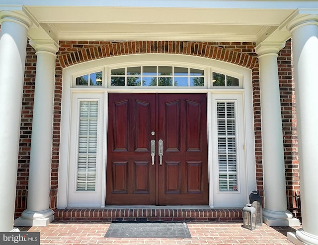 entrance to property featuring brick siding