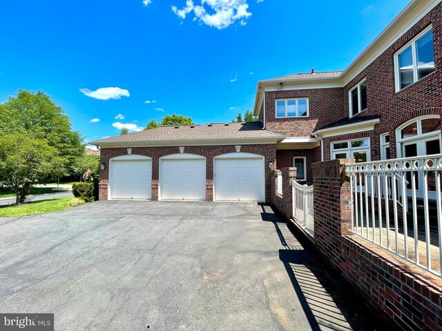 view of front of property with brick siding and an attached garage