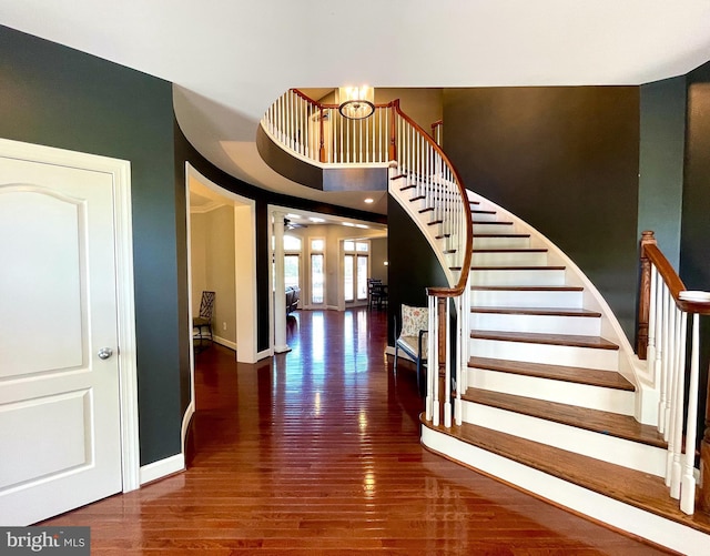 foyer featuring wood finished floors, stairs, baseboards, and a ceiling fan