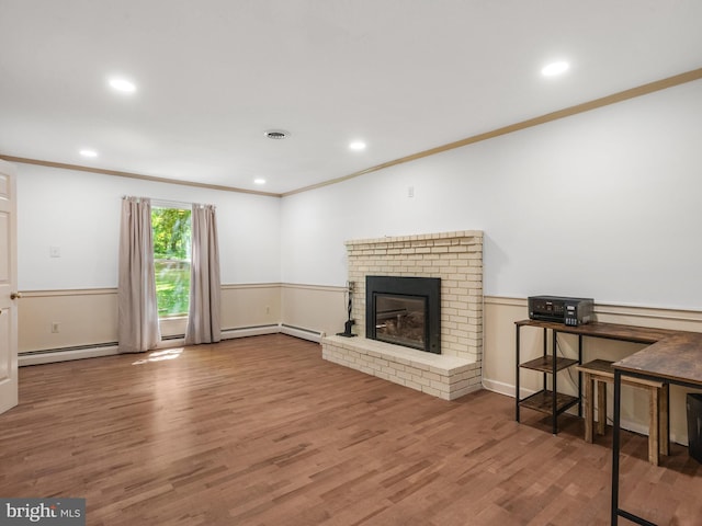 51 Seminary Rd, Glenmoore, PA 19343 - unfurnished living room featuring crown molding, wood finished floors, a fireplace, recessed lighting, and a baseboard radiator