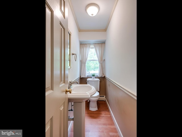 51 Seminary Rd, Glenmoore, PA 19343 - bathroom featuring toilet, ornamental molding, wood finished floors, baseboard heating, and baseboards