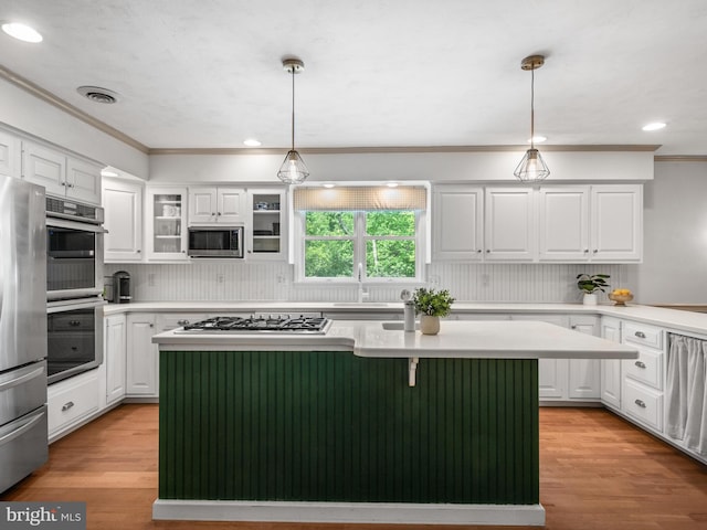 51 Seminary Rd, Glenmoore, PA 19343 - kitchen featuring stainless steel appliances, a center island, white cabinetry, a sink, and ornamental molding