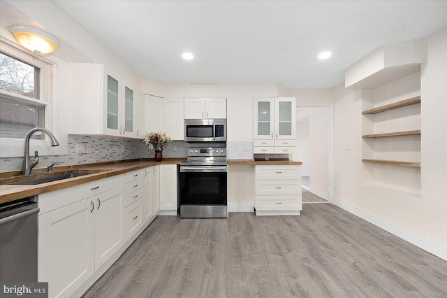 8422 Newark Rd, Newark, MD 21841 - kitchen featuring stainless steel appliances, a sink, butcher block counters, white cabinetry, and recessed lighting