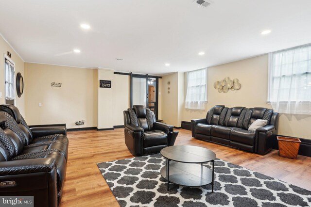 430 W Palmer St, Morrisville, PA 19067 - living room featuring a barn door, light wood-style floors, recessed lighting, and baseboards