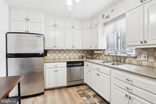 430 W Palmer St, Morrisville, PA 19067 - kitchen featuring stainless steel appliances, a sink, white cabinetry, and backsplash
