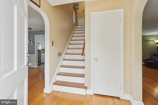 430 W Palmer St, Morrisville, PA 19067 - stairway featuring arched walkways, wood finished floors, and baseboards
