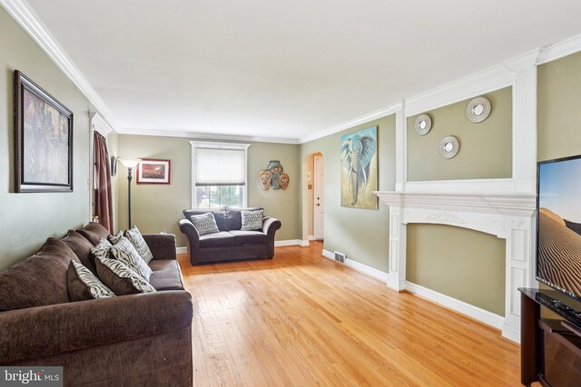 430 W Palmer St, Morrisville, PA 19067 - living room featuring light wood-style flooring, crown molding, a fireplace, and baseboards