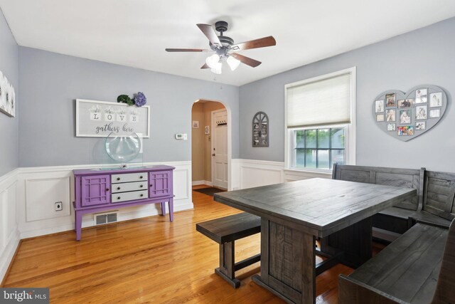 430 W Palmer St, Morrisville, PA 19067 - dining space with arched walkways, ceiling fan, a wainscoted wall, wood finished floors, and breakfast area