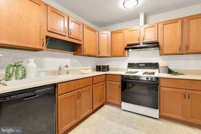 6008 Hawthorne St, Cheverly, MD 20785 - kitchen with range with gas cooktop, dishwasher, under cabinet range hood, a sink, and light countertops