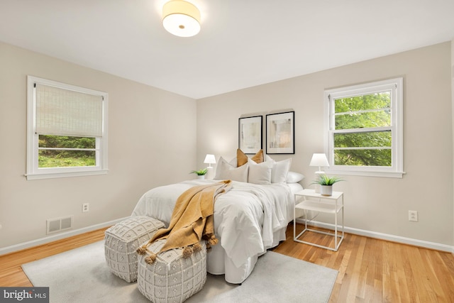 6008 Hawthorne St, Cheverly, MD 20785 - bedroom featuring multiple windows, baseboards, and wood finished floors