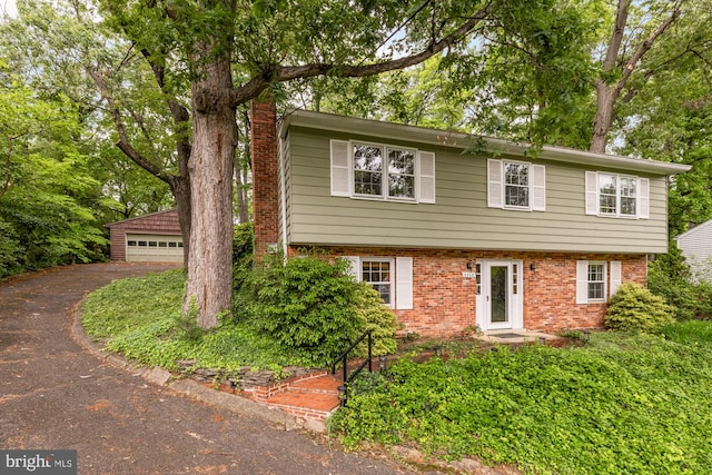 6008 Hawthorne St, Cheverly, MD 20785 - colonial inspired home with brick siding, a chimney, and a garage