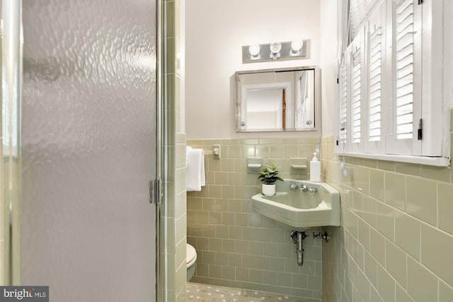 6008 Hawthorne St, Cheverly, MD 20785 - full bathroom featuring toilet, a shower stall, tile walls, a sink, and wainscoting