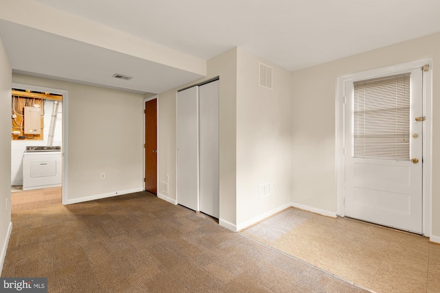 6008 Hawthorne St, Cheverly, MD 20785 - unfurnished bedroom featuring washer / clothes dryer, baseboards, electric panel, and a closet