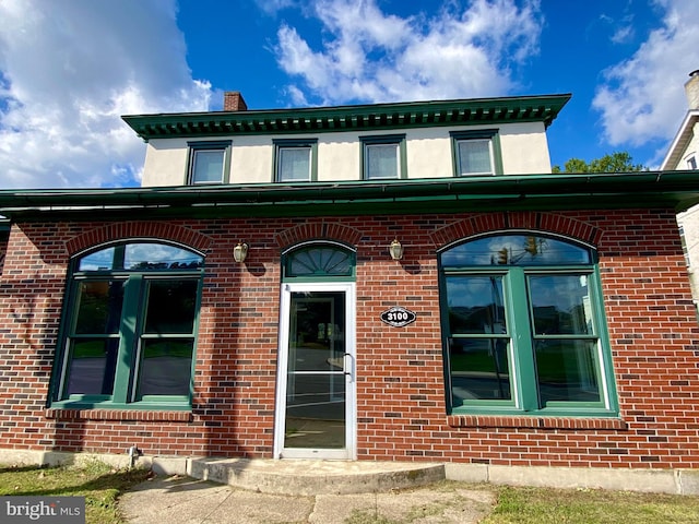 entrance to property with brick siding