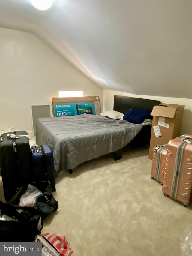 bedroom featuring vaulted ceiling and carpet flooring