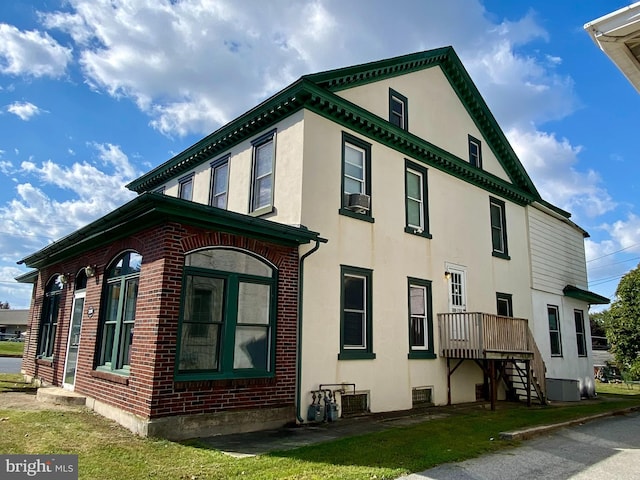 view of property exterior with stucco siding and central AC