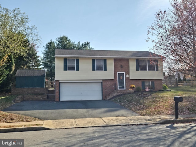 40 Homestead Dr, Denver, PA 17517 - raised ranch featuring brick siding, an attached garage, and asphalt driveway