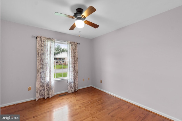 empty room with light wood-type flooring, baseboards, and ceiling fan