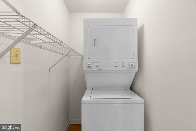 laundry area with stacked washer and clothes dryer