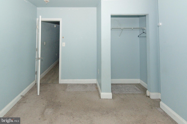 unfurnished bedroom featuring carpet floors, a closet, and baseboards