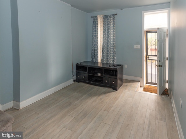entryway featuring light wood finished floors and baseboards