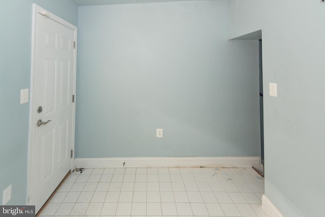 unfurnished room featuring baseboards