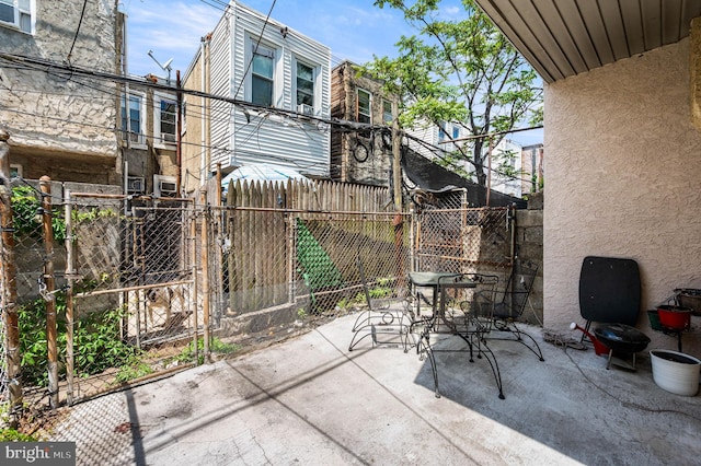 view of patio with a gate and fence