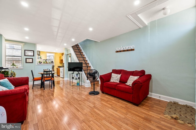 living room with wood finished floors, stairs, baseboards, and recessed lighting