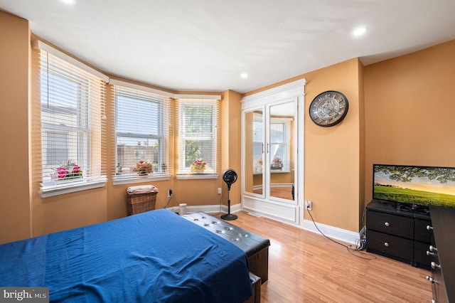 bedroom with baseboards, wood finished floors, and recessed lighting