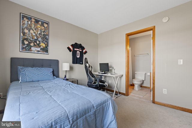 carpeted bedroom with baseboards and connected bathroom