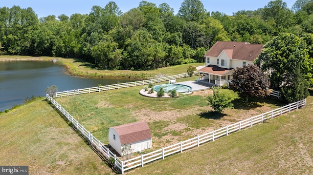 view from above of property featuring a large body of water and a heavily wooded area