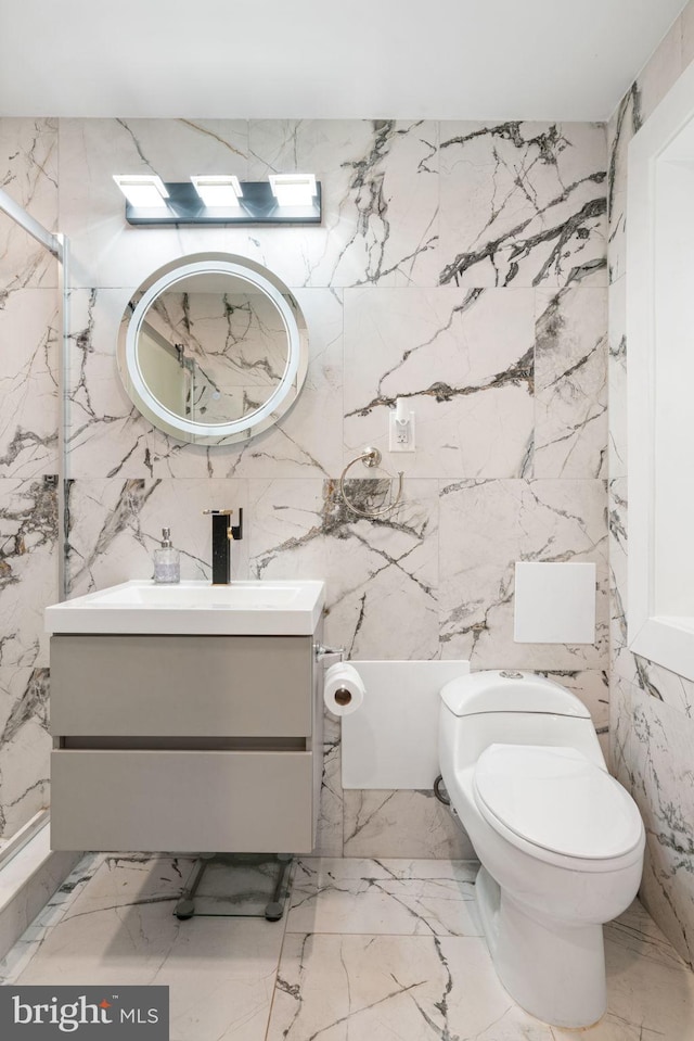 6415 Wilcox Ct, Alexandria, VA 22310 - bathroom with vanity, marble tiled flooring, stone wall, tile walls, and toilet
