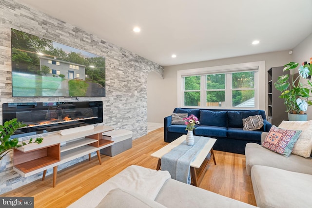 6415 Wilcox Ct, Alexandria, VA 22310 - living area with a stone fireplace, wood finished floors, recessed lighting, and arched walkways