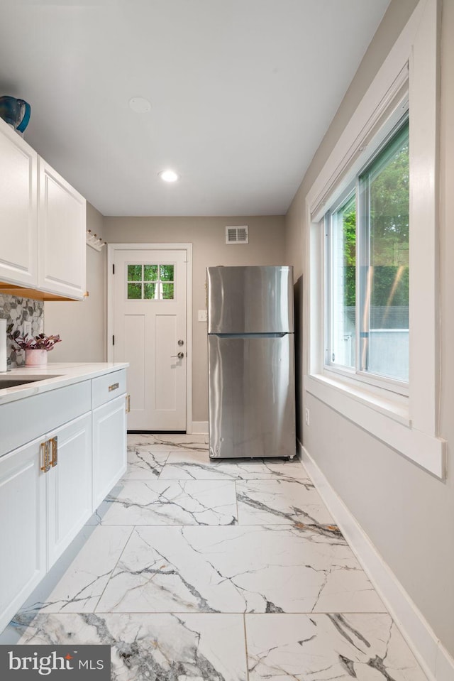 6415 Wilcox Ct, Alexandria, VA 22310 - kitchen with freestanding refrigerator, recessed lighting, plenty of natural light, and light marble finish flooring