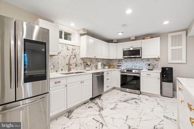 6415 Wilcox Ct, Alexandria, VA 22310 - kitchen featuring appliances with stainless steel finishes, a sink, light countertops, recessed lighting, and white cabinetry