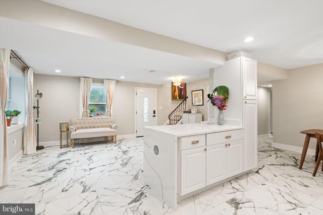6415 Wilcox Ct, Alexandria, VA 22310 - kitchen with white cabinets, recessed lighting, open floor plan, baseboards, and light stone counters