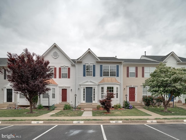 13195 Golders Green Pl, Bristow, VA 20136 - townhome / multi-family property with uncovered parking, entry steps, and a standing seam roof