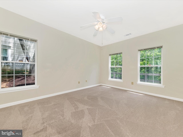 unfurnished room featuring carpet, baseboards, and a ceiling fan