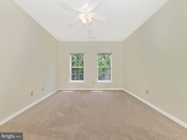 unfurnished room with baseboards, carpet flooring, and a ceiling fan