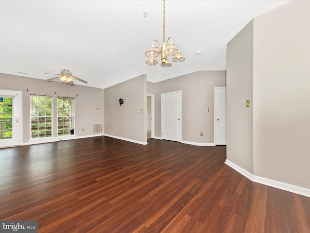 unfurnished living room with dark wood-type flooring, ceiling fan, a chandelier, and baseboards