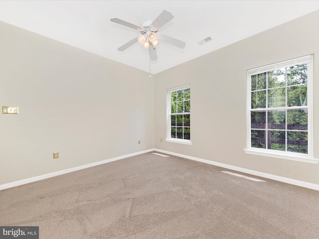 empty room featuring baseboards, carpet flooring, and ceiling fan