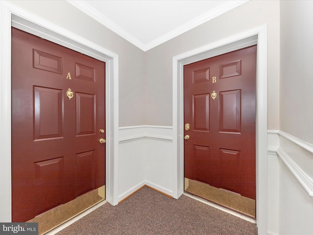 entryway with crown molding and carpet floors