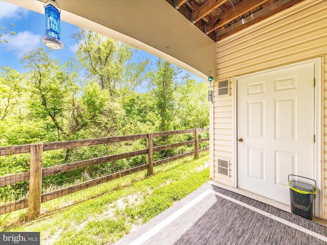 entrance to property featuring fence