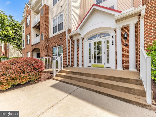 view of exterior entry with brick siding