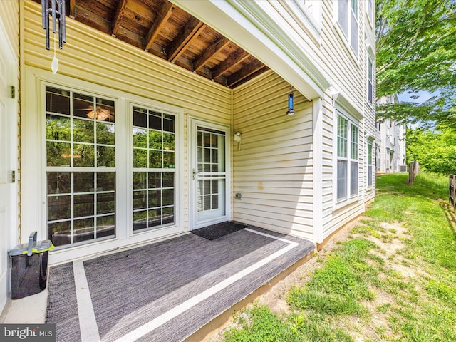 view of exterior entry with a wooden deck