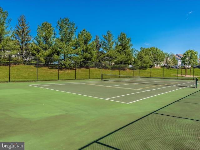 view of tennis court featuring fence and community basketball court