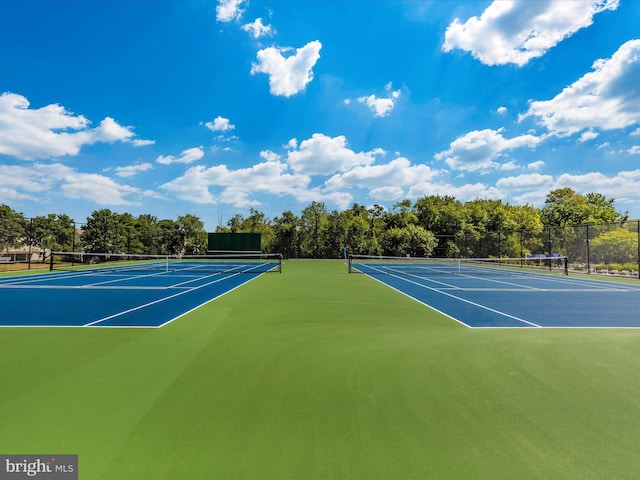 view of tennis court with fence and community basketball court