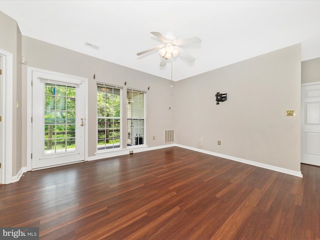 unfurnished room with wood finished floors, ceiling fan, and baseboards